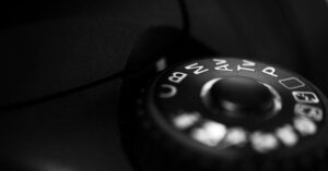 Detailed close-up of a camera mode dial highlighting settings in black and white contrast.