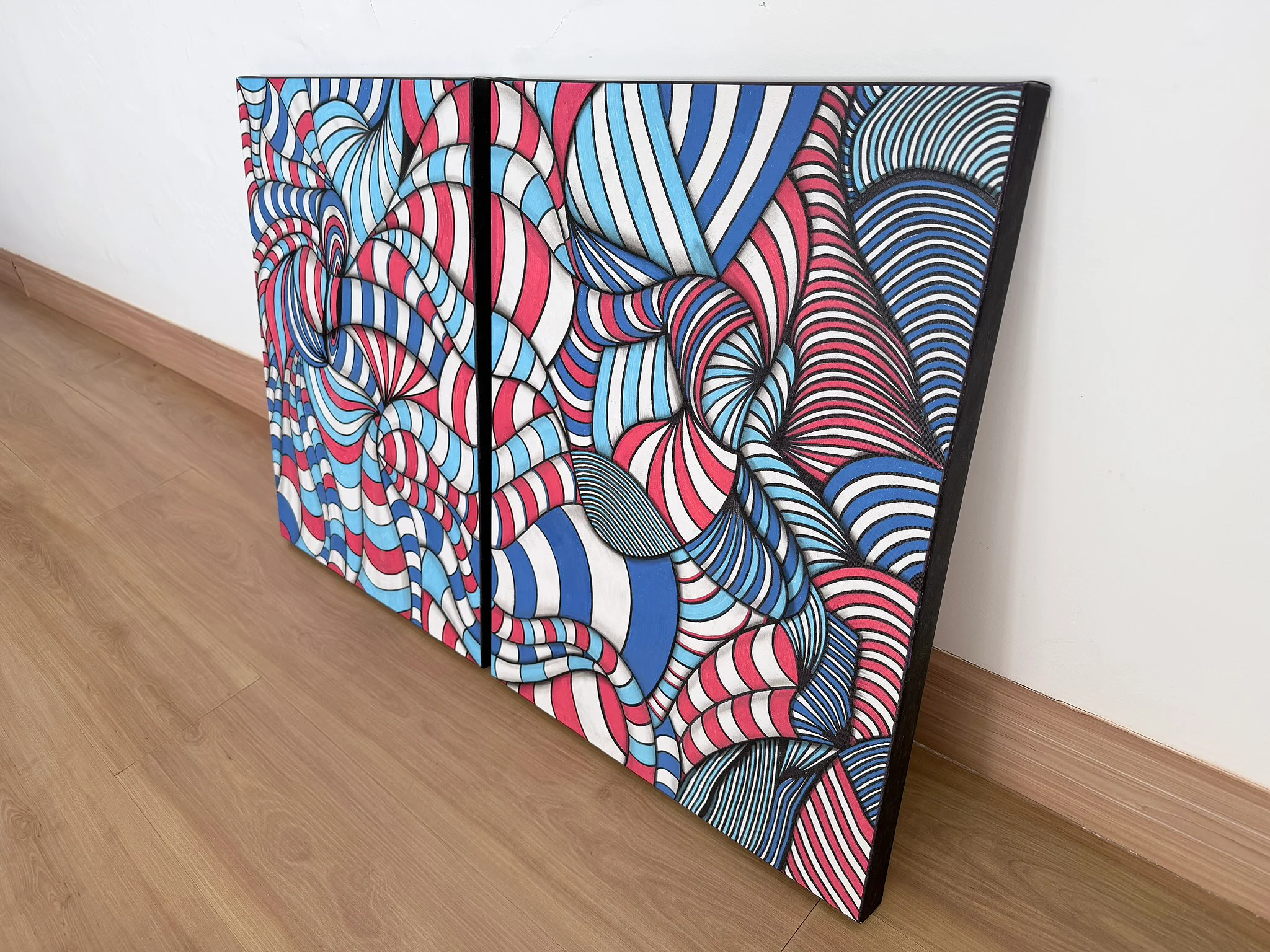 Chromatic Pulse is built from repetition under pressure. Across two individual canvases measuring 50 × 65 cm each, bands of red, cobalt blue, cyan, white and black bend, compress and expand into a dense system of visual movement. What first appears geometric quickly becomes organic. Lines become waves, surfaces begin to fold, and the composition seems to move beyond the physical limits of the canvas. Created with ink, marker and pastel on canvas, the work retains the immediacy of the artist’s hand. The repeated lines are precise enough to establish structure, yet irregular enough to prevent the image from becoming mechanical. This tension between discipline and distortion gives the diptych its energy. The two-panel format intensifies the work. A physical gap separates the canvases, yet the visual language continues across both surfaces. That interruption creates tension: two independent works operating as one larger composition. Color is not used simply for decoration. Red generates pressure and acceleration. Blue and cyan establish depth and counterbalance. White creates expansion, while black anchors the entire structure. Together they create a highly visible chromatic field that changes according to viewing distance. From across a room, Chromatic Pulse reads as a bold and immediate statement. At close range, the individual lines, intersections and hand-worked surfaces reveal a much more intricate construction. Conceived for collectors seeking art with presence, the diptych is particularly effective in contemporary residences, luxury interiors, offices, hospitality environments and architectural spaces where artwork is expected to define the atmosphere. This is a unique original two-panel artwork, created by hand on canvas and hand-signed. No edition reproduces the physical original. Free shipping included.